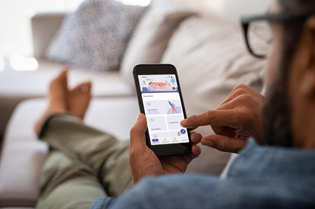 A man is using a mobile app. The app is called OmaVAV.