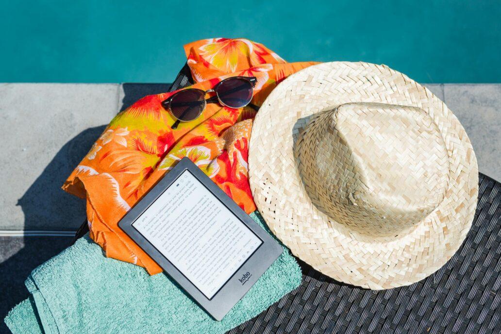 a summer hat, sunglasses and a towel